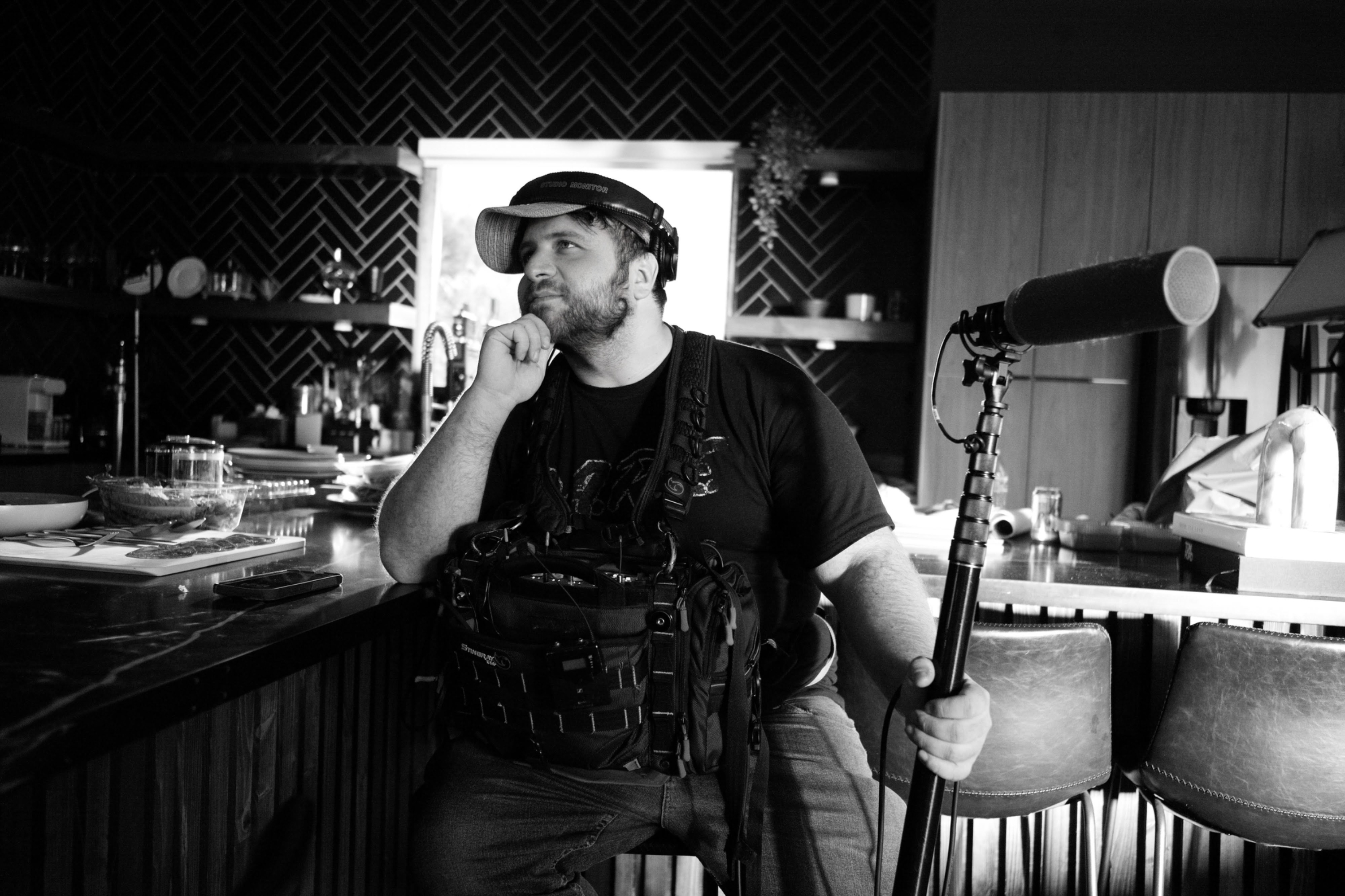 Eric Fisher on set with headphones, sound bag and boom microphone